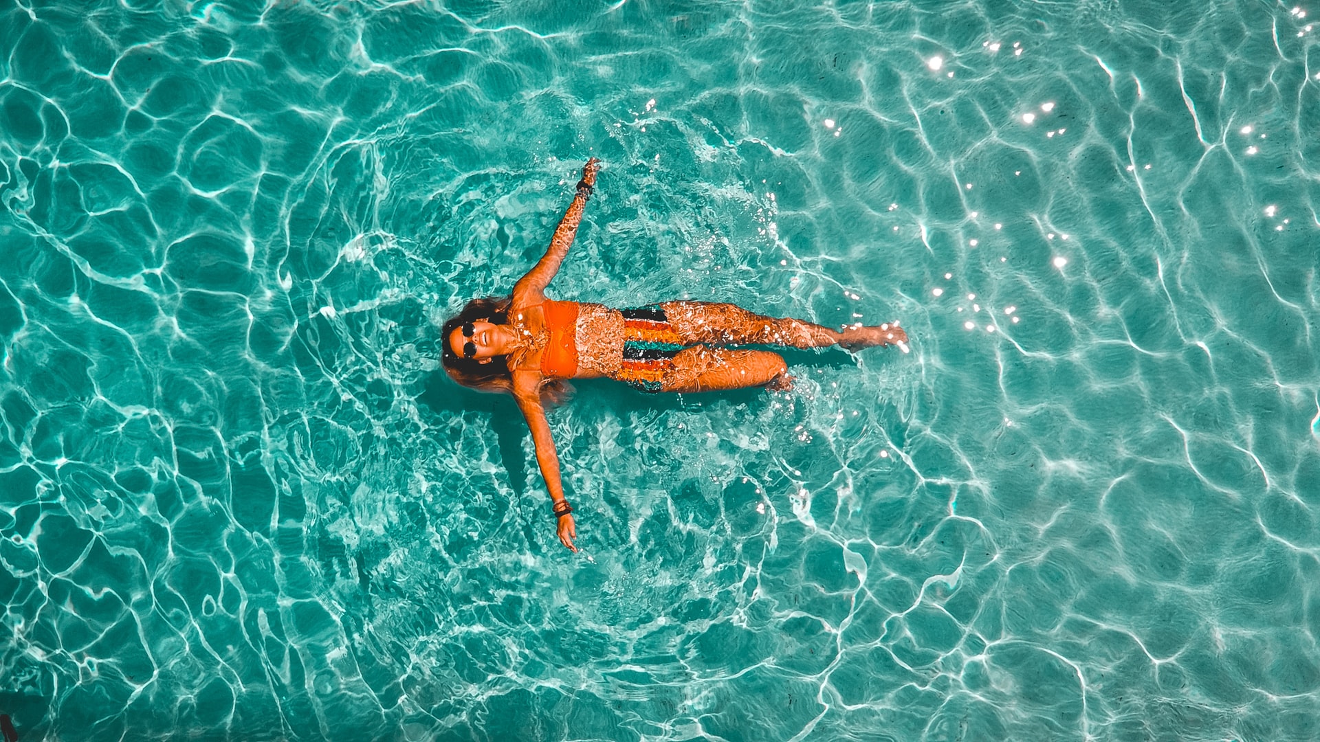 Blys blog - Seven New Ways To Have The Best Staycation Ever And Three Reasons Why It Might Just Change Your Life - aerial photo of woman floating in pool