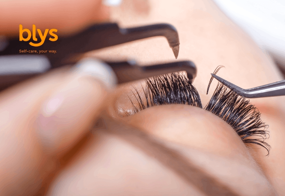 Beauty technician using tweezers to apply lash extensions, emphasizing precision, self-care, and professional lash treatment.