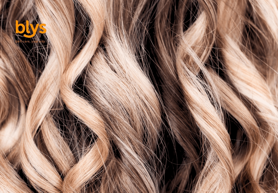 Close-up of balayage curls with soft waves and textured strands, creating a luxurious, warm, salon-inspired beauty mood.